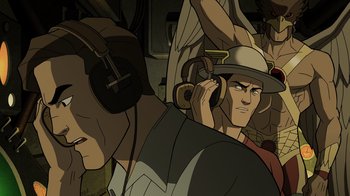 Movie still from “Justice Society: World War II” (2021), directed by Jeff Wamester – A man with headphones is listening to music; Close Up shot, Overhead angle
