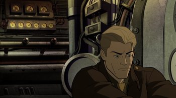 Movie still from “Justice Society: World War II” (2021), directed by Jeff Wamester – A man with blond hair is sitting in front of a machine; Medium shot, High angle