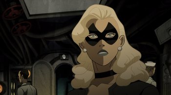 Movie still from “Justice Society: World War II” (2021), directed by Jeff Wamester – A woman with blonde hair wearing a black mask; Close Up shot, Over the shoulder angle