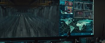 Movie still from “Kandahar” (2023), directed by Ric Roman Waugh – A computer screen with a map of the world on it; Wide shot, Over the shoulder angle