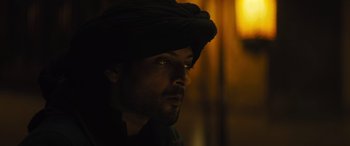 Movie still from “Kandahar” (2023), directed by Ric Roman Waugh – A person wearing a turban; Close Up shot, Low angle