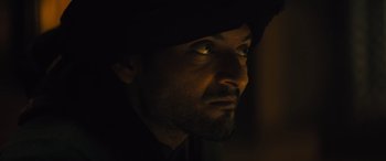 Movie still from “Kandahar” (2023), directed by Ric Roman Waugh – A person wearing a hat; Close Up shot, Low angle