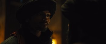 Movie still from “Kandahar” (2023), directed by Ric Roman Waugh – A person wearing a hooded jacket; Close Up shot, Over the shoulder angle