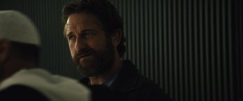 Movie still from “Kandahar” (2023), directed by Ric Roman Waugh – A person with a beard; Close Up shot, Over the shoulder angle