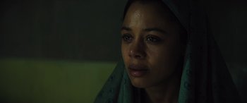 Movie still from “Kandahar” (2023), directed by Ric Roman Waugh – A person wearing a head scarf; Close Up shot, Low angle