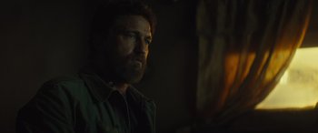 Movie still from “Kandahar” (2023), directed by Ric Roman Waugh – A person with a beard; Close Up shot, Over the shoulder angle