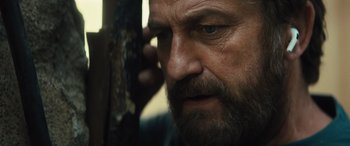 Movie still from “Kandahar” (2023), directed by Ric Roman Waugh – A person with a beard; Close Up shot, Over the shoulder angle