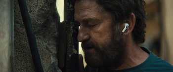Movie still from “Kandahar” (2023), directed by Ric Roman Waugh – A person with his eyes closed; Close Up shot, Over the shoulder angle