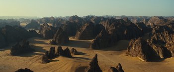 Movie still from “Kandahar” (2023), directed by Ric Roman Waugh – A view of a mountain range in the desert; Extreme Wide shot, High angle