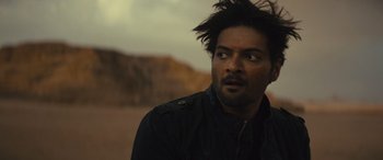 Movie still from “Kandahar” (2023), directed by Ric Roman Waugh – A person wearing a black jacket; Close Up shot, Over the shoulder angle