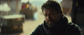 Movie still from “Kandahar” (2023), directed by Ric Roman Waugh – A person with a beard; Close Up shot, Over the shoulder angle