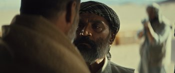 Movie still from “Kandahar” (2023), directed by Ric Roman Waugh – A man with a beard is looking at another man with a beard; Close Up shot, Over the shoulder angle
