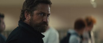 Movie still from “Kandahar” (2023), directed by Ric Roman Waugh – A person with a beard; Close Up shot, Over the shoulder angle