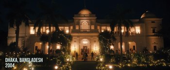 Movie still from “Khufiya” (2023), directed by Vishal Bhardwaj – People are standing in front of a building at night; Extreme Wide shot, Low angle