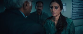 Movie still from “Khufiya” (2023), directed by Vishal Bhardwaj – A woman in a green shirt looking at a man in a black suit; Close Up shot, Over the shoulder angle