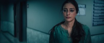 Movie still from “Khufiya” (2023), directed by Vishal Bhardwaj – A woman in a green dress looking at the camera; Close Up shot, High angle