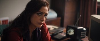Movie still from “Khufiya” (2023), directed by Vishal Bhardwaj – A person sitting at a desk; Close Up shot, Over the shoulder angle