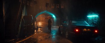 Movie still from “Khufiya” (2023), directed by Vishal Bhardwaj – A person with an umbrella walking down a street at night; Extreme Wide shot, Low angle