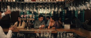 Movie still from “Khufiya” (2023), directed by Vishal Bhardwaj – A man and a woman sitting at a bar talking; Medium shot, Over the shoulder angle