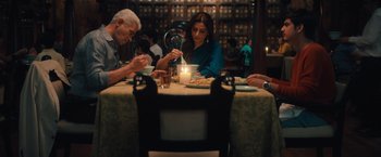 Movie still from “Khufiya” (2023), directed by Vishal Bhardwaj – A group of people sitting at a table eating food; Medium shot, Low angle