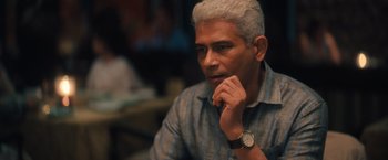 Movie still from “Khufiya” (2023), directed by Vishal Bhardwaj – An older man sitting at a table with his hand under his chin; Close Up shot, Over the shoulder angle