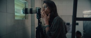 Movie still from “Khufiya” (2023), directed by Vishal Bhardwaj – A woman smoking a cigarette while taking a picture of herself; Close Up shot, Overhead angle