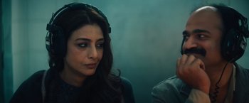 Movie still from “Khufiya” (2023), directed by Vishal Bhardwaj – A woman sitting next to a man in front of a wall; Close Up shot, Over the shoulder angle