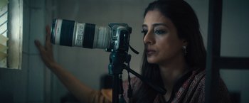 Movie still from “Khufiya” (2023), directed by Vishal Bhardwaj – A woman taking a picture with a video camera; Close Up shot, Low angle
