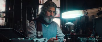 Movie still from “Khufiya” (2023), directed by Vishal Bhardwaj – A man with a beard and a scarf is looking at a candle; Close Up shot, Low angle