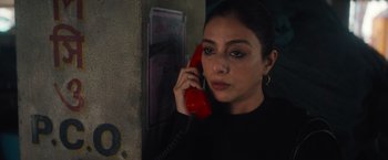 Movie still from “Khufiya” (2023), directed by Vishal Bhardwaj – A woman is talking on a red phone; Close Up shot, High angle