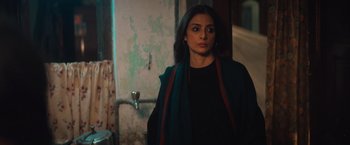 Movie still from “Khufiya” (2023), directed by Vishal Bhardwaj – A woman standing in front of a bathroom door; Medium shot, Over the shoulder angle