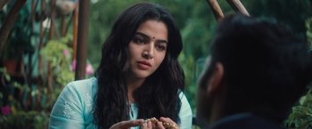 Movie still from “Khufiya” (2023), directed by Vishal Bhardwaj – A woman sitting in front of a man eating a donut; Close Up shot, Over the shoulder angle