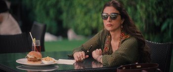 Movie still from “Khufiya” (2023), directed by Vishal Bhardwaj – A woman sitting at a table writing on a piece of paper; Medium shot, High angle