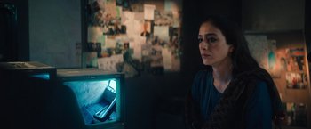 Movie still from “Khufiya” (2023), directed by Vishal Bhardwaj – A woman sitting in front of a television; Close Up shot, Over the shoulder angle