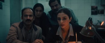 Movie still from “Khufiya” (2023), directed by Vishal Bhardwaj – A group of people sitting around a table; Medium shot, High angle