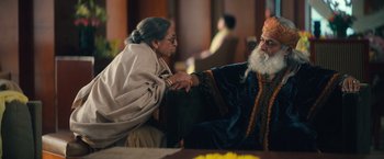 Movie still from “Khufiya” (2023), directed by Vishal Bhardwaj – An older man and woman shake hands in a room; Medium shot, Over the shoulder angle