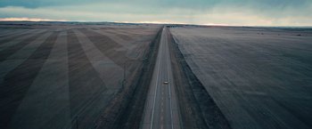 Movie still from “Khufiya” (2023), directed by Vishal Bhardwaj – An aerial view of an empty road in the middle of the day; Extreme Wide shot, High angle