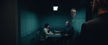 Movie still from “Khufiya” (2023), directed by Vishal Bhardwaj – Two people sitting at a table in a room; Wide shot, Over the shoulder angle