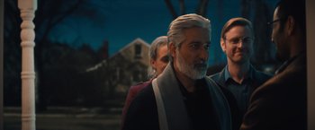 Movie still from “Khufiya” (2023), directed by Vishal Bhardwaj – A group of people standing next to each other in front of a building; Medium shot, Over the shoulder angle