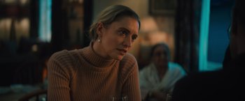 Movie still from “Khufiya” (2023), directed by Vishal Bhardwaj – A woman sitting at a table with a glass of wine; Close Up shot, Low angle