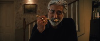 Movie still from “Khufiya” (2023), directed by Vishal Bhardwaj – A man with a beard and mustache eating food; Close Up shot, Low angle