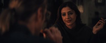 Movie still from “Khufiya” (2023), directed by Vishal Bhardwaj – A woman looking into a mirror while holding a cell phone; Close Up shot, Over the shoulder angle