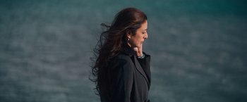 Movie still from “Khufiya” (2023), directed by Vishal Bhardwaj – A woman in a black jacket standing in front of the ocean; Close Up shot, High angle