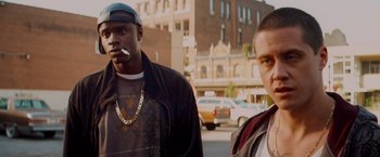 Movie still from “Kick-Ass” (2010), directed by Matthew Vaughn – Two men standing next to each other on the street; Close Up shot, Over the shoulder angle