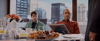 Movie still from “Kick-Ass” (2010), directed by Matthew Vaughn – Two people sitting at a table with a plate of cupcakes; Medium shot, Over the shoulder angle