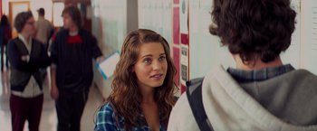Movie still from “Kick-Ass” (2010), directed by Matthew Vaughn – A woman with long brown curly hair talking to a man; Close Up shot, Over the shoulder angle