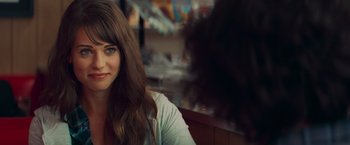 Movie still from “Kick-Ass” (2010), directed by Matthew Vaughn – A person sitting at a table; Close Up shot, Over the shoulder angle