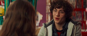 Movie still from “Kick-Ass” (2010), directed by Matthew Vaughn – A young man wearing glasses talking to a woman; Close Up shot, Over the shoulder angle