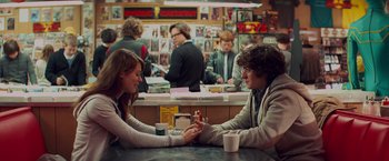 Movie still from “Kick-Ass” (2010), directed by Matthew Vaughn – A man and a woman sitting at a table; Medium shot, Over the shoulder angle