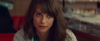 Movie still from “Kick-Ass” (2010), directed by Matthew Vaughn – A person with long hair and blue eyes; Close Up shot, Over the shoulder angle